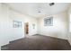 Bright bedroom features a ceiling fan, neutral walls and carpet, and natural light from a window at 5450 E Mclellan Rd # 133, Mesa, AZ 85205