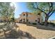 Exterior view of a multi-story condo with well-maintained lawn and mature shade trees at 5450 E Mclellan Rd # 133, Mesa, AZ 85205