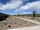 Walking path, perfect for an evening stroll, with desert landscaping and a wall at 5515 W Hopi Trl, Laveen, AZ 85339