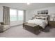 Bright main bedroom features large windows, neutral decor, and carpeted floors at 5828 W Willow Ridge Dr, Laveen, AZ 85339