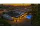 Sunset aerial view of house with solar panels, backyard pool, covered patio, and meticulous landscaping at 5916 E Hearn Rd, Scottsdale, AZ 85254