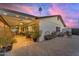View of a backyard featuring a covered patio, brick pavers, and desert landscaping at 5916 E Hearn Rd, Scottsdale, AZ 85254