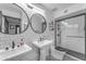 A bright bathroom features white subway tiles, dual sinks, modern fixtures, and a glass shower at 5916 E Hearn Rd, Scottsdale, AZ 85254