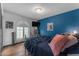 A bedroom with a modern design, including a unique arched window and a vivid blue accent wall at 5916 E Hearn Rd, Scottsdale, AZ 85254