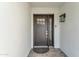 A welcoming front door with a stylish matte black finish, sidelight, and modern hardware at 5916 E Hearn Rd, Scottsdale, AZ 85254
