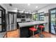 Modern kitchen features an island with bar seating, stainless appliances, and ample lighting at 5916 E Hearn Rd, Scottsdale, AZ 85254