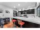 Modern kitchen boasts an island with seating and stainless steel appliances at 5916 E Hearn Rd, Scottsdale, AZ 85254