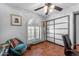 This home office features light from a shuttered window and contains decoratively framed pictures at 5916 E Hearn Rd, Scottsdale, AZ 85254