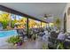 This stylish covered patio features ample seating and views of the pool at 5916 E Hearn Rd, Scottsdale, AZ 85254