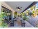 A spacious covered patio includes a long dining table with benches, ceiling fan, and pool views at 5916 E Hearn Rd, Scottsdale, AZ 85254