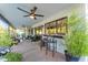 A covered patio features ample seating and bar-stool seating at a large window at 5916 E Hearn Rd, Scottsdale, AZ 85254
