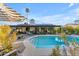 A backyard pool with patio, lounge seating, and lush tropical landscaping at 5916 E Hearn Rd, Scottsdale, AZ 85254