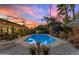 Inviting pool with lounge chairs is surrounded by lush landscaping and patio furniture at 5916 E Hearn Rd, Scottsdale, AZ 85254