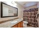 Well-lit bathroom with a granite countertop, decorative shower curtain, and neutral color scheme at 6760 S Russet Sky Way, Gold Canyon, AZ 85118