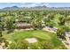 Aerial view of homes, mature trees, and the community golf course at 7155 E Oakmont Dr, Paradise Valley, AZ 85253