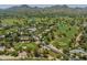 Community aerial view featuring rolling green golf courses, mountains and mature landscaping at 7155 E Oakmont Dr, Paradise Valley, AZ 85253