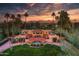 Grand estate boasts lush landscaping, stunning mountain views, and a circular driveway at 7155 E Oakmont Dr, Paradise Valley, AZ 85253