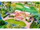 Luxury home featuring a terracotta roof, a pool, and a lush green lawn situated on a golf course at 7155 E Oakmont Dr, Paradise Valley, AZ 85253