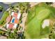 Aerial view of a tile roofed estate home and a golf course with mature landscaping surrounding the property at 7155 E Oakmont Dr, Paradise Valley, AZ 85253