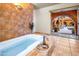 Luxurious bathroom with soaking tub and doorway to the backyard at 7155 E Oakmont Dr, Paradise Valley, AZ 85253