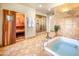 Luxurious bathroom with soaking tub, walk-in shower, and sauna room at 7155 E Oakmont Dr, Paradise Valley, AZ 85253