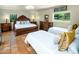 Well-lit bedroom showcasing a spacious layout with a large bed and well-crafted wood furniture at 7155 E Oakmont Dr, Paradise Valley, AZ 85253