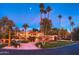 Charming home with a well-manicured lawn, circular drive, and mature palm trees at 7155 E Oakmont Dr, Paradise Valley, AZ 85253