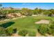 Aerial view of golf course, mature trees, and property in the background at 7155 E Oakmont Dr, Paradise Valley, AZ 85253