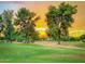 Scenic sunset view of the community golf course with mature shade trees at 7155 E Oakmont Dr, Paradise Valley, AZ 85253