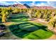 Aerial view of a golf course with lush green grass and desert mountain views at 7155 E Oakmont Dr, Paradise Valley, AZ 85253