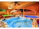 Luxurious hot tub with brick accents and an adjacent pool, offering a relaxing spa-like experience at 7155 E Oakmont Dr, Paradise Valley, AZ 85253