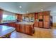 Spacious kitchen with custom wood cabinetry, granite countertops, tile flooring, and modern appliances at 7155 E Oakmont Dr, Paradise Valley, AZ 85253