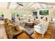Bright and airy living room with vaulted ceilings, tile flooring, and elegant furnishings at 7155 E Oakmont Dr, Paradise Valley, AZ 85253
