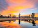 Scenic sunset reflecting on a pond surrounded by trees and a golf course at 7155 E Oakmont Dr, Paradise Valley, AZ 85253