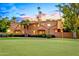 Beautiful exterior elevation with palm trees and expansive backyard at 7155 E Oakmont Dr, Paradise Valley, AZ 85253