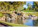 Picturesque waterfall feature flowing into a pond on the golf course at 7155 E Oakmont Dr, Paradise Valley, AZ 85253