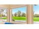 Bright window view overlooking the manicured golf course with lush green fairways and mature desert landscaping at 7155 E Oakmont Dr, Paradise Valley, AZ 85253