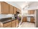 Open kitchen area with stainless steel appliances, granite counters and modern lighting at 9175 N 107Th Way, Scottsdale, AZ 85258