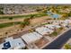 Aerial view of homes in a community, showcasing the golf course and community lake at 10818 W Palmeras Dr, Sun City, AZ 85373