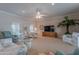 Spacious living room area featuring carpet, ceiling fan and neutral-toned walls at 10818 W Palmeras Dr, Sun City, AZ 85373