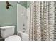 Bright bathroom featuring a tub with white tile surround and a decorative shower curtain at 11021 E Castle Dome Trl, Gold Canyon, AZ 85118