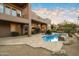 Expansive backyard featuring a beautiful pool, desert landscaping, and a seamless indoor-outdoor living experience at 11082 E Mark Ln, Scottsdale, AZ 85262