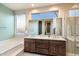 Bright bathroom features dual sinks, ample vanity space, and a luxurious soaking tub at 11082 E Mark Ln, Scottsdale, AZ 85262
