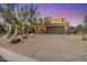 Desert home features beautiful desert landscaping, a large driveway, and a two-car garage at 11082 E Mark Ln, Scottsdale, AZ 85262