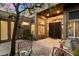 Inviting courtyard with stone tile, potted plants, outdoor seating, and a decorative iron gate at 11082 E Mark Ln, Scottsdale, AZ 85262