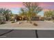 Charming desert home with drought-resistant landscaping, a two-car garage, and a picturesque Arizona sunset at 11082 E Mark Ln, Scottsdale, AZ 85262