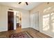 Open floorplan living room boasts tile floors and a door to the balcony for seamless indoor/outdoor living at 11082 E Mark Ln, Scottsdale, AZ 85262