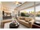 Sun-drenched living space with large windows offers views of backyard landscaping and a glimpse of the kitchen at 11082 E Mark Ln, Scottsdale, AZ 85262