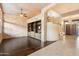 Spacious living room with hardwood floors, custom built-ins and curved staircase at 11082 E Mark Ln, Scottsdale, AZ 85262