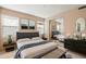Comfortable main bedroom features a large bed, stylish decor, and a mirrored closet for ample storage at 11082 E Mark Ln, Scottsdale, AZ 85262